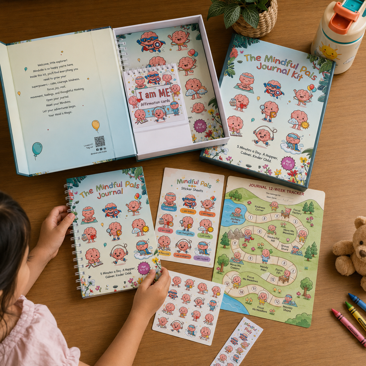 Children's mindful activities kit with journal, stickers, and coloring book on a wooden table.